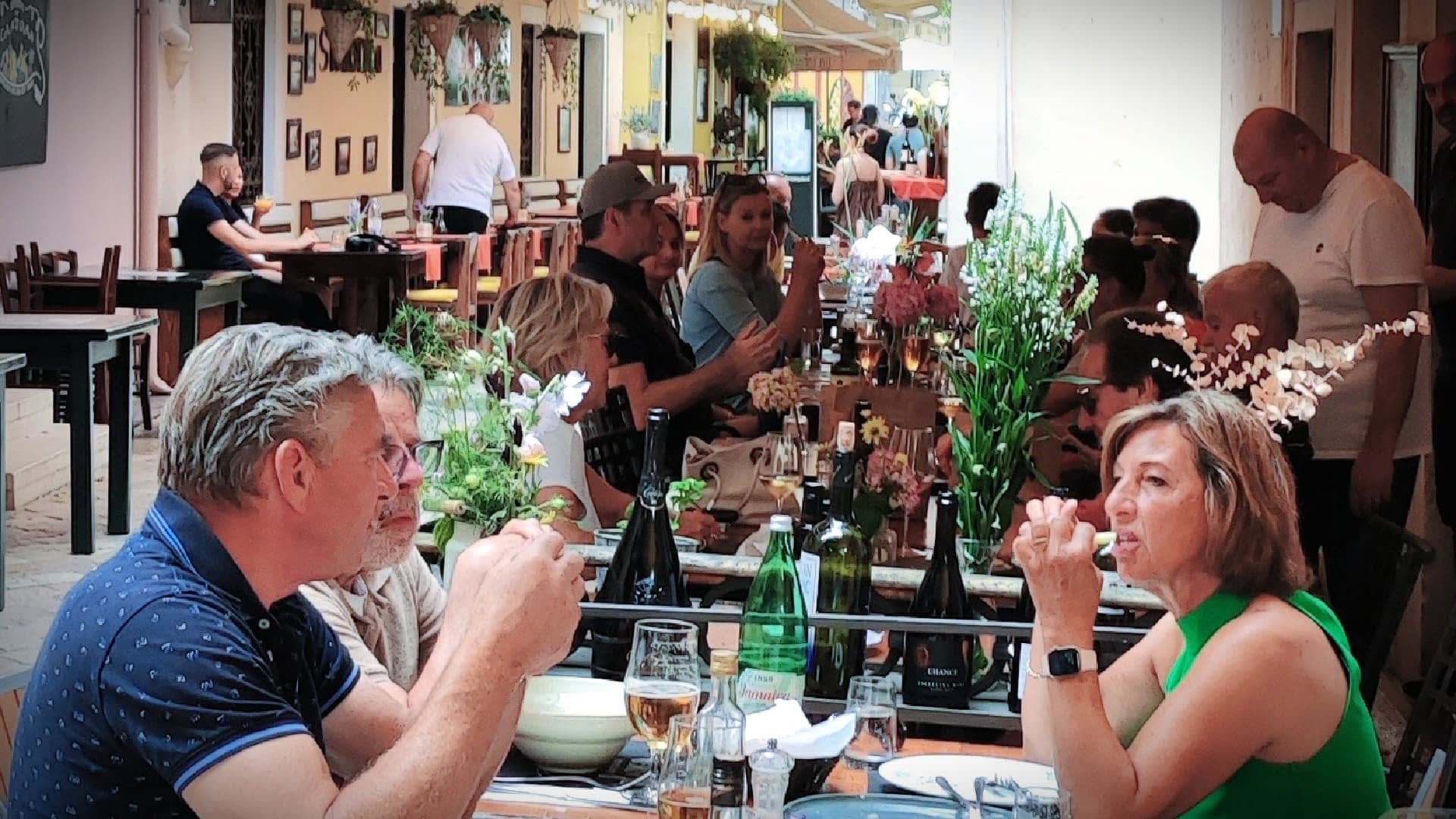A couple sitting at a table in a restaurant, engaged in conversation while dining. - Olive Oil Times