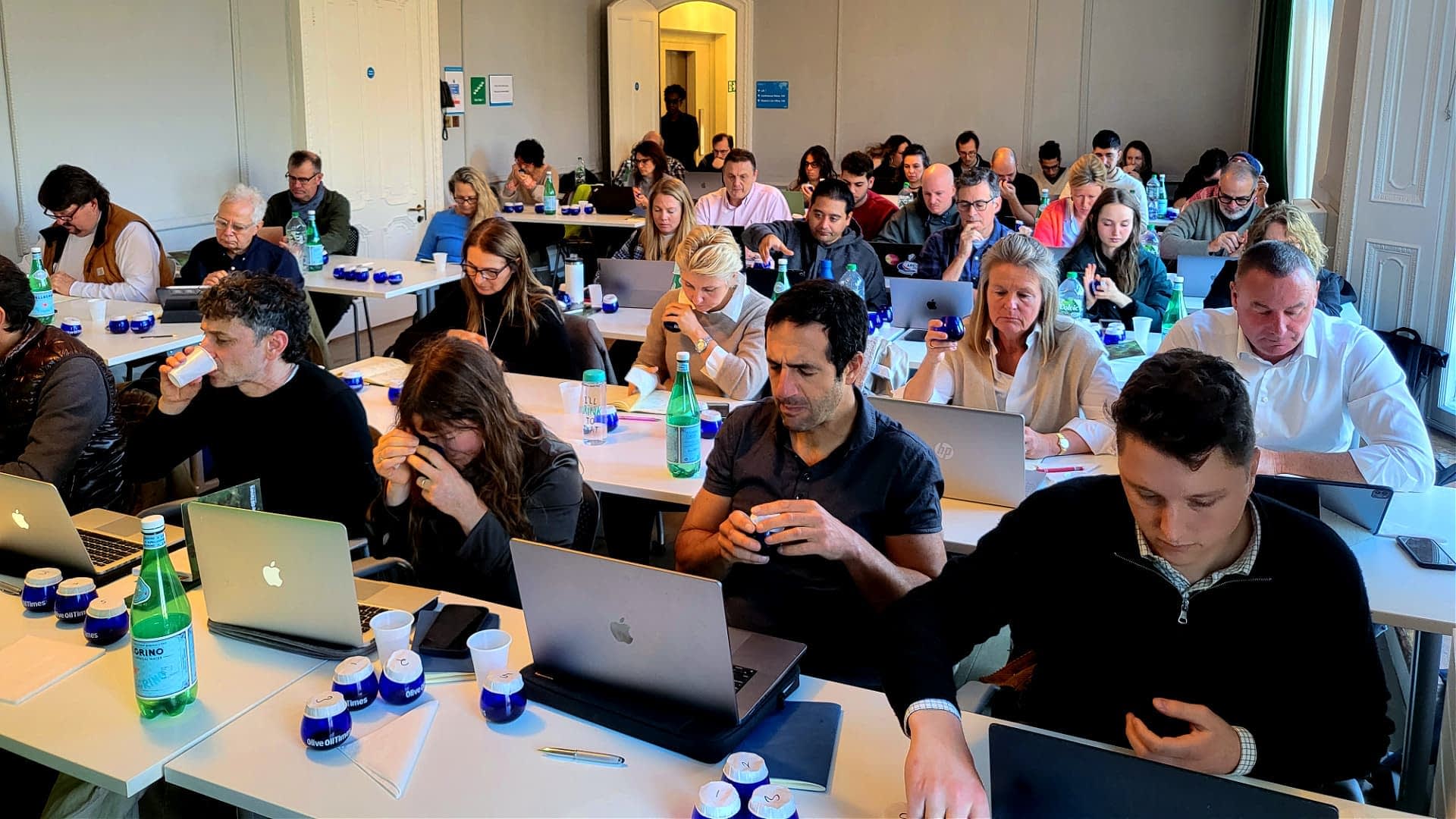 Participants seated at tables with laptops during a workshop session, focused on their tasks. - Olive Oil Times