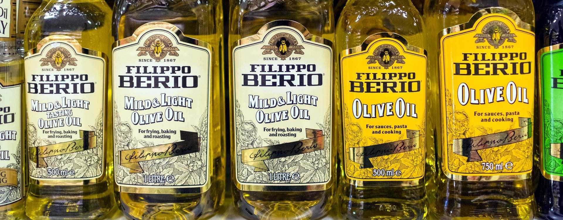 П’ять пляшок оливкової олії Filippo Berio різних типів, включаючи м’які та легкі варіанти. - Olive Oil Times