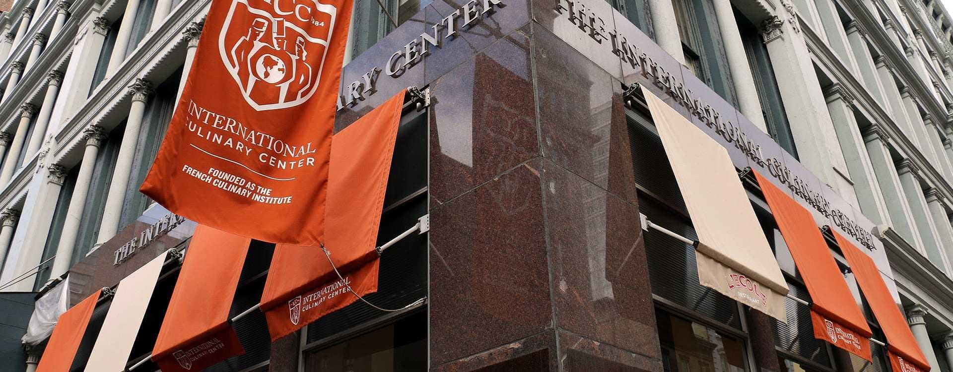 Exterior view of the International Culinary Center with banners on the facade. - Olive Oil Times