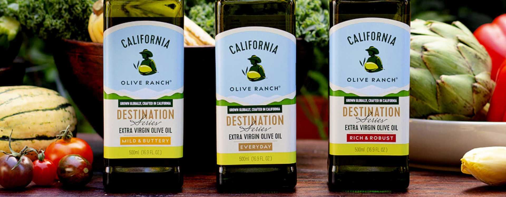 Three bottles of California Olive Ranch extra virgin olive oil with different labels: Mild & Buttery, Everyday, Rich & Robust. - Olive Oil Times