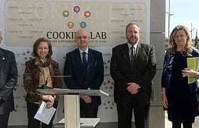 A group of six individuals standing in front of a Cooking Lab sign during an event. - Olive Oil Times
