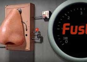 An electronic nose device with a large nose structure and a gauge labeled 'Fusty' on the side. - Olive Oil Times