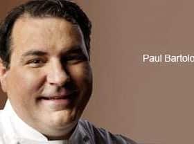 Portrait of chef Paul Bartolotta smiling against a neutral background. - Olive Oil Times