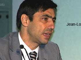 Jean-Louis Barjol speaking into a microphone during a conference presentation. - Olive Oil Times