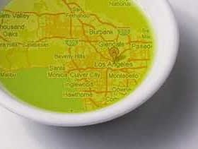 Map of Los Angeles displayed in a small white dish filled with olive oil. - Olive Oil Times