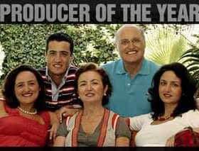 Group of five individuals posing for a family portrait with 'Producer of the Year 2010' text above them. - Olive Oil Times