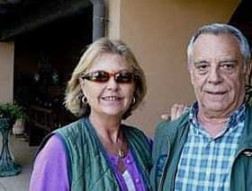 A man and a woman posing for a photo outdoors, both wearing sunglasses and casual attire. - Olive Oil Times