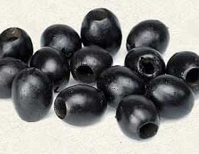 A group of black olives arranged on a light background, showcasing their oval shape and dark color. - Olive Oil Times
