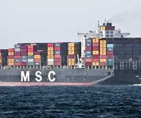 Large container ship named MSC carrying colorful shipping containers on the ocean. - Olive Oil Times