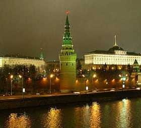 Night view of the Moscow Kremlin with illuminated towers and buildings along the river. - Olive Oil Times
