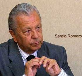 Sergio Romero Pizarro seated and looking thoughtfully with hands clasped together. - Olive Oil Times