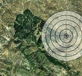 Satellite view of a landscape with a circular target overlay in the center. - Olive Oil Times