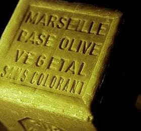 A rectangular block of Marseille soap labeled 'Base Olive Vegetal Sans Colorant'. - Olive Oil Times