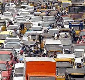 A congested urban road filled with various vehicles in a traffic jam. - Olive Oil Times