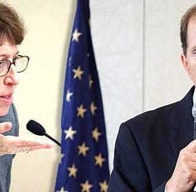 Two individuals in a discussion, one speaking into a microphone and the other gesturing with their hand. - Olive Oil Times