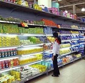 Grocery store aisle displaying a variety of packaged products on shelves. - Olive Oil Times