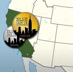 Two circular medals representing the New York International Olive Oil Competition with skyline designs. - Olive Oil Times