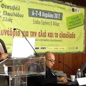 Speaker presenting at a conference about olive oil and olive cultivation with an audience in attendance. - Olive Oil Times