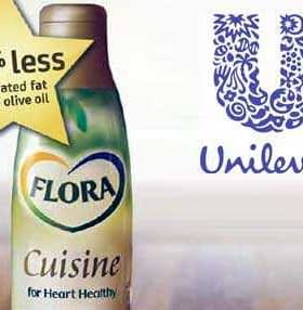 Bottle of Flora Cuisine cooking oil with a label indicating 45% less saturated fat than olive oil. - Olive Oil Times