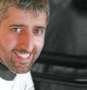 Portrait of Yiannis Tsivourakis smiling while wearing a chef's uniform. - Olive Oil Times