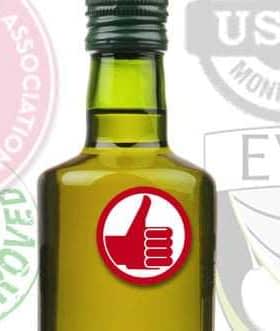 Green glass bottle of olive oil featuring various certification seals in the background. - Olive Oil Times