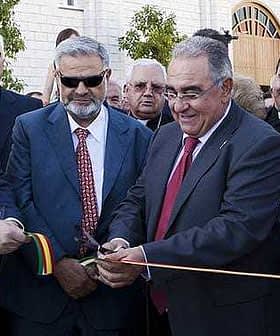 Group of officials participating in a ribbon cutting ceremony with scissors and ribbon. - Olive Oil Times