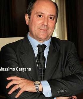 Portrait of Massimo Gargano with arms crossed, wearing a suit and tie. - Olive Oil Times