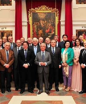 A group of individuals in formal attire posing for a photograph in an indoor setting. - Olive Oil Times