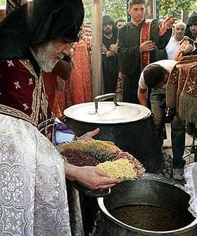 Cleric in traditional attire holding bowls of grains during a religious ceremony. - Olive Oil Times
