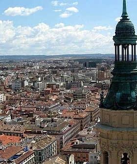 Aerial view of Zaragoza city featuring a prominent tower with a green dome. - Olive Oil Times