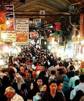 A busy market in Tehran filled with people and various stalls displaying goods. - Olive Oil Times