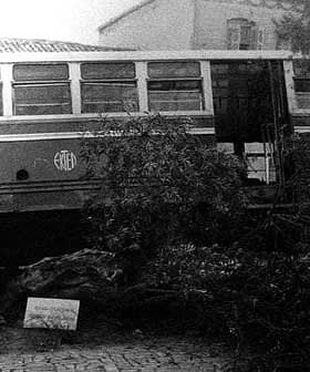 An old bus partially obscured by vegetation, showing signs of wear and age. - Olive Oil Times
