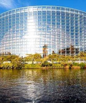 Modern glass structure of the European Parliament building located in Strasbourg, France, reflecting sunlight. - Olive Oil Times