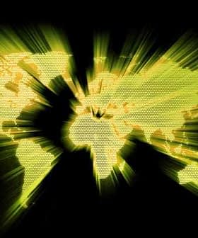 A world map displayed in yellow with radiating lines on a black background. - Olive Oil Times