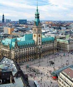 Aerial view of Hamburg City Hall with surrounding buildings and streets in the city. - Olive Oil Times