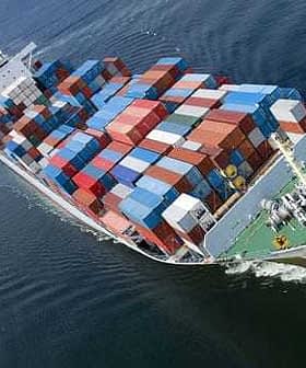 Cargo ship with multiple stacked shipping containers navigating through water. - Olive Oil Times