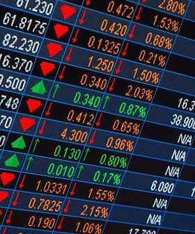 Stock market ticker displaying various stock prices with green and red indicators for changes. - Olive Oil Times