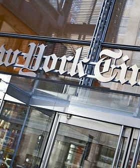 Entrance sign of The New York Times building with the name displayed prominently. - Olive Oil Times
