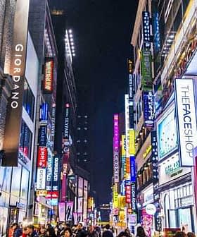 Illuminated shopping street in South Korea with various storefronts and signs at night. - Olive Oil Times