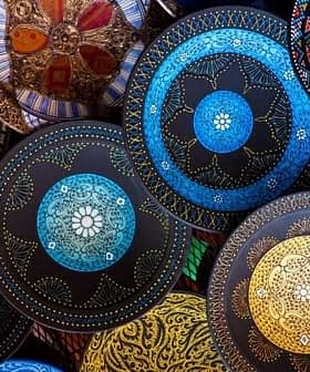 Collection of decorative hand-painted ceramic plates featuring intricate designs in various colors. - Olive Oil Times