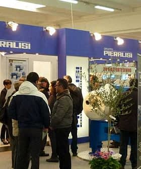 Piaralisi exhibition booth with attendees interacting at a trade show event. - Olive Oil Times