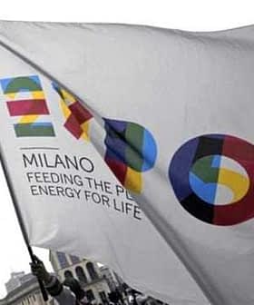 Flag featuring the Expo Milano logo with colorful graphics and the text 'Feeding the Planet, Energy for Life'. - Olive Oil Times