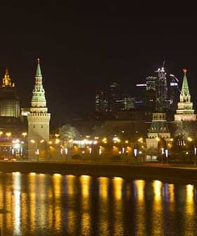 Night view of the Moscow Kremlin with illuminated towers and buildings along the river. - Olive Oil Times