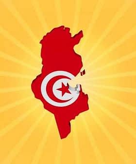 Silhouette of Tunisia filled with the national flag colors on a yellow background. - Olive Oil Times