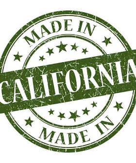 Green circular stamp with the text 'Made in California' and stars in a distressed style. - Olive Oil Times