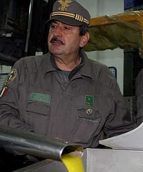 Two officials in military uniforms observing an oil extraction process in a facility. - Olive Oil Times