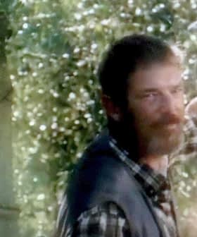 A man with a beard and a woman smiling, both appearing in a natural outdoor setting. - Olive Oil Times