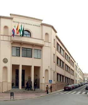 Two educational buildings in Jaén, featuring flags and distinct architectural styles. - Olive Oil Times