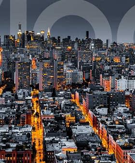 Aerial view of New York City skyline at night with illuminated buildings and streets. - Olive Oil Times